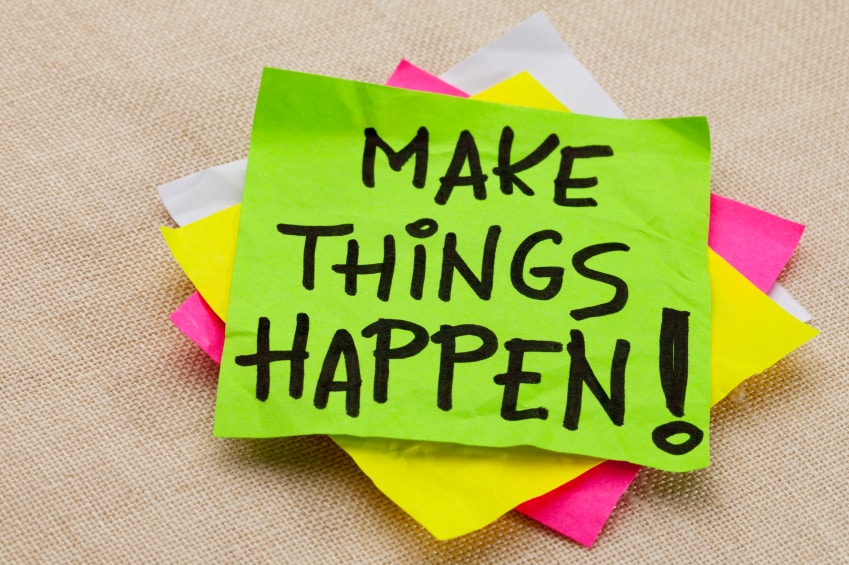 Make things happen motivational reminder - handwriting on a green sticky note
