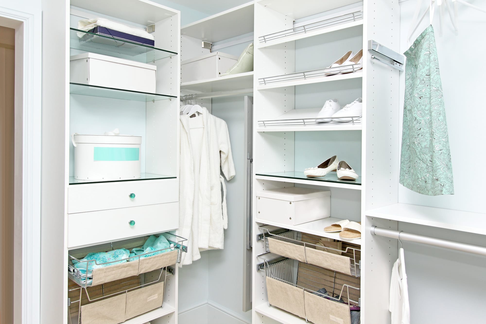 Detail of large walk in closet with modern wardrobe on hangers