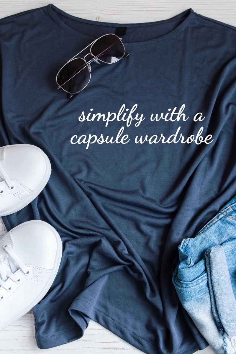 text reads simplify with a capsule wardrobe superimposed on top of a navy tee shirt, sunglasses, jeans and white tennis shoes